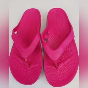 CROCS woman's bright pink slip on flip flop sandals Size US 7